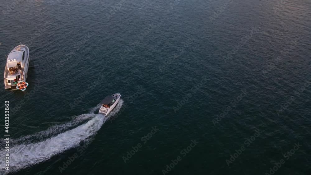 Aerial view around a boat, driving in middle of yachts, on the Key Biscayne Bay, near Miami, Florida, USA - orbit, drone shot Aerial view around a boat, driving in middle of yachts, on the Key Biscayne Bay, near Miami, Florida, USA - orbit, drone shot