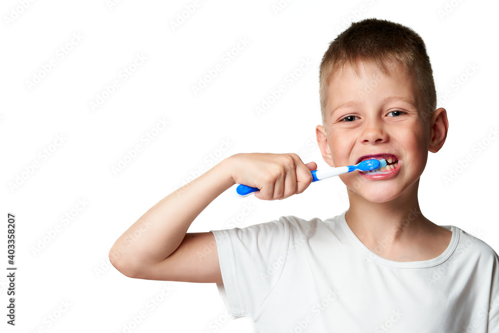 Cute little boy brushes his teeth with toothpaste and a brush Cute little boy brushes his teeth with toothpaste and a brush