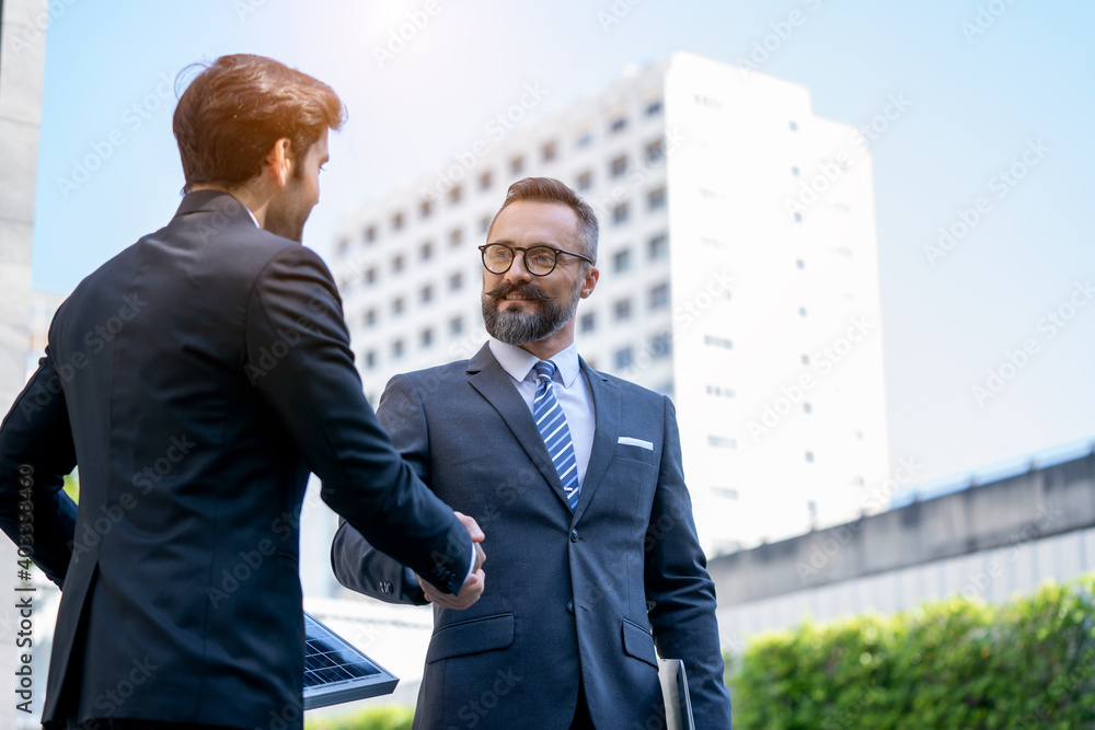 Electrical Engineer Technician Talk to business people and shaking hands after finishing up a meeting,Renewable energy solar panel concept. Electrical Engineer Technician Talk to business people and shaking hands after finishing up a meeting,Renewable energy solar panel concept.