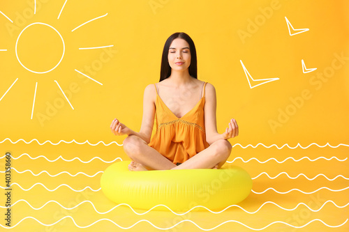 Meditating young woman with...
