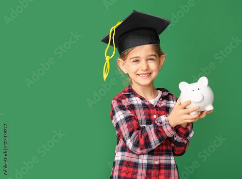 Cute girl with piggy bank o...