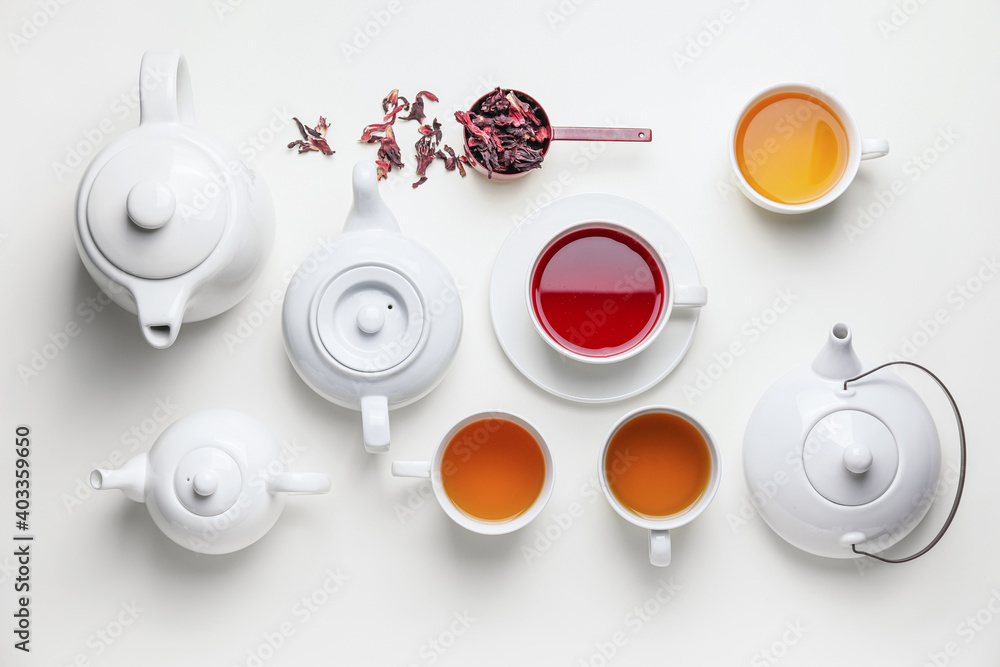 Composition with teapots and cups of tea on white background - obrazy, fototapety, plakaty 