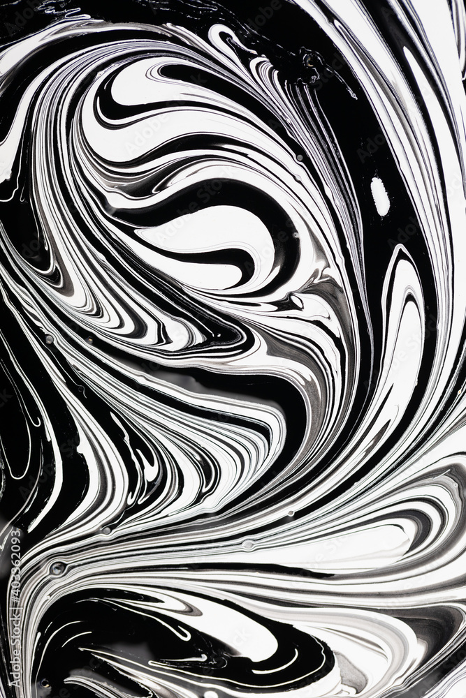 Fototapeta premium abstract black and white pattern. swirls on liquid glossy paint surface