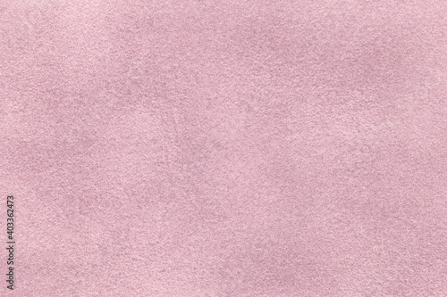 Light lilac matte background of suede fabric, closeup. Velvet texture of textile