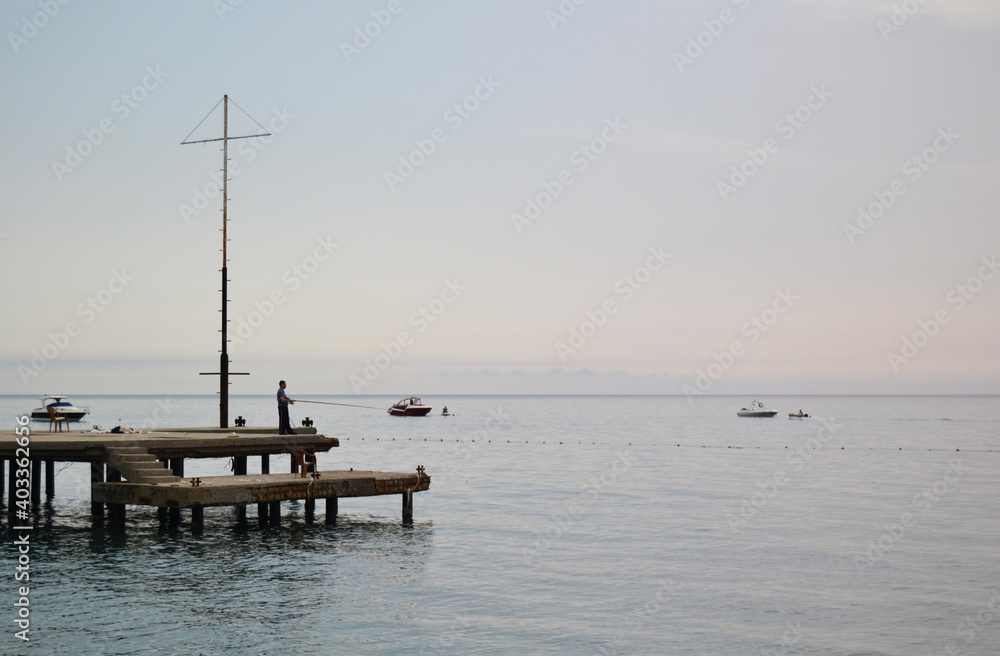 Fototapeta premium calm at sea in the first rays of the sun