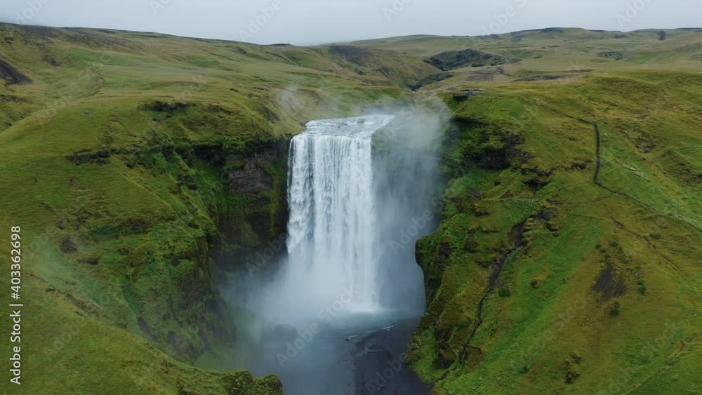 Aerial fly above Skogafoss waterfall on Skoga river on South Iceland in summer. Popular tourist attraction. Aerial fly above Skogafoss waterfall on Skoga river on South Iceland in summer. Popular tourist attraction.