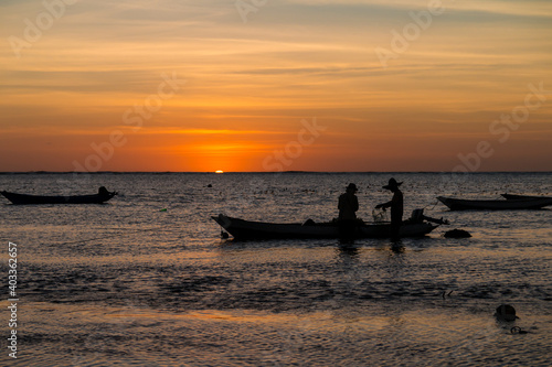 Sumba,Indonesia-September 2020: Fisherman fishing at the boat the water with ship with sunset views