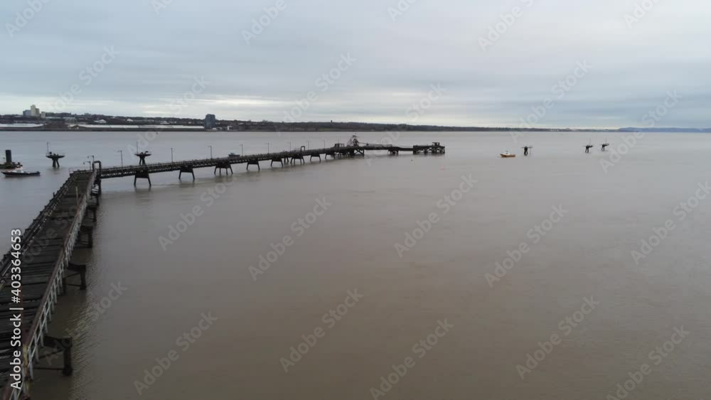 Drone view Tranmere oil terminal Birkenhead coastal petrochemical harbour distribution overfly orbit over pipeline