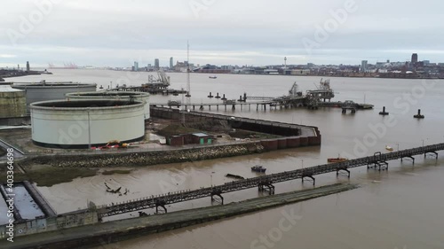 Drone view Tranmere oil terminal Birkenhead coastal petrochemical harbour distribution descend pull back photo