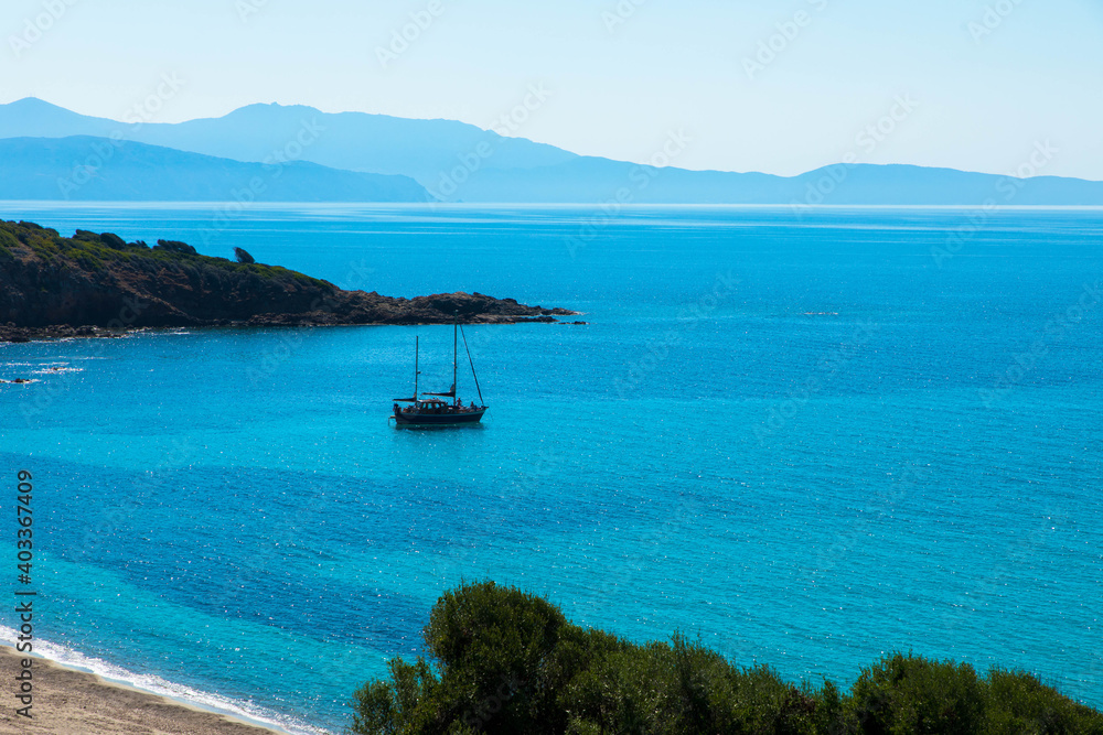 Spectacular view of Golfe de Sagone with a motorboat in the bay, near Cargese. Place for Text. Corsica, France