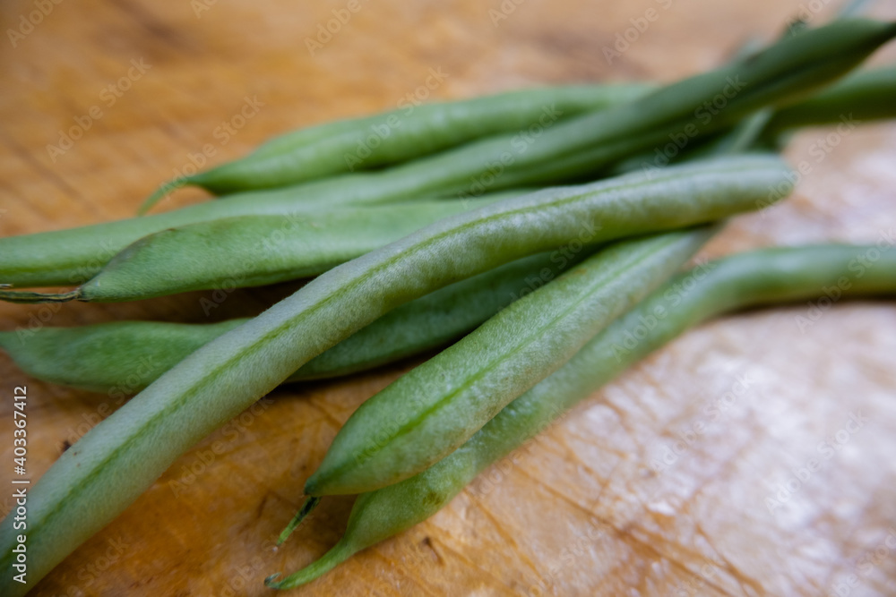 Green beans isolated on a scratched wooden table Green beans isolated on a scratched wooden table