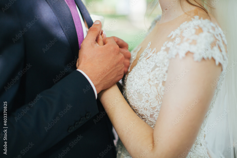 Lovers hold hands. Newlyweds. Wedding. A man holds a woman's hand.Romance. Lovers hold hands. Newlyweds. Wedding. A man holds a woman's hand.Romance.