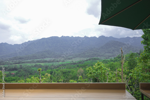 horizon forest mountain view cloudy sky with table and umbrella table