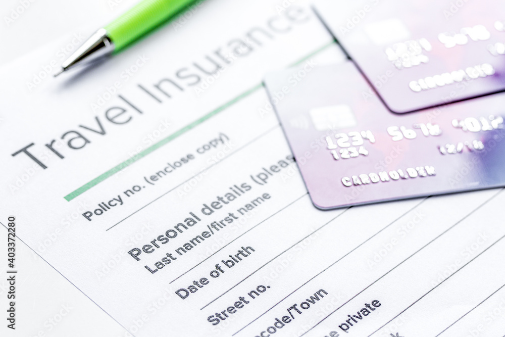 Traveling concept with insurance application on white table Traveling concept with insurance application on white table