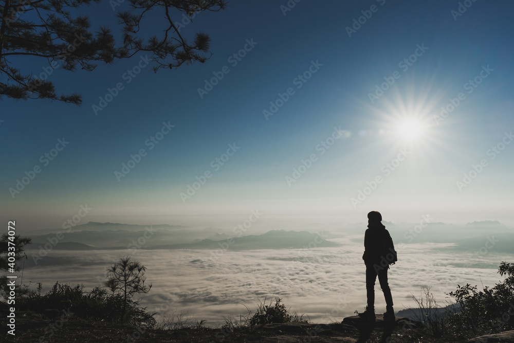 Tourist standing and enjoy the view on top of the mountains and sea of cloud.