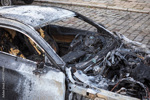 Burned car close-up. Car after the fire, crime of vandalism, riots. Arson car. Accident on the road due to speeding. Explosion. 
