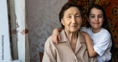 a little girl is laughing with her great-grandmother