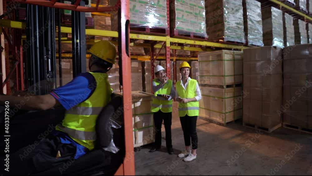 Asian male and female warehouse worker talking and checks inventory stock on goods shelf in distribution fulfillment center. eCommerce, B2B global business and freight transportation logistic concept. Asian male and female warehouse worker talking and checks inventory stock on goods shelf in distribution fulfillment center. eCommerce, B2B global business and freight transportation logistic concept.
