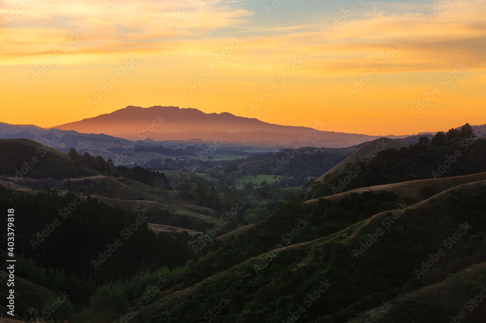 Sunset in the mountains. A view from the hills around Raglan, New Zealand, looking towards Mount Karioi