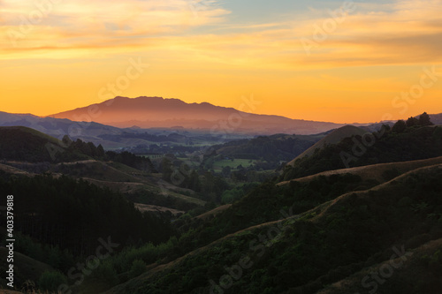 Sunset in the mountains. A view from the hills around Raglan, New Zealand, looking towards Mount Karioi