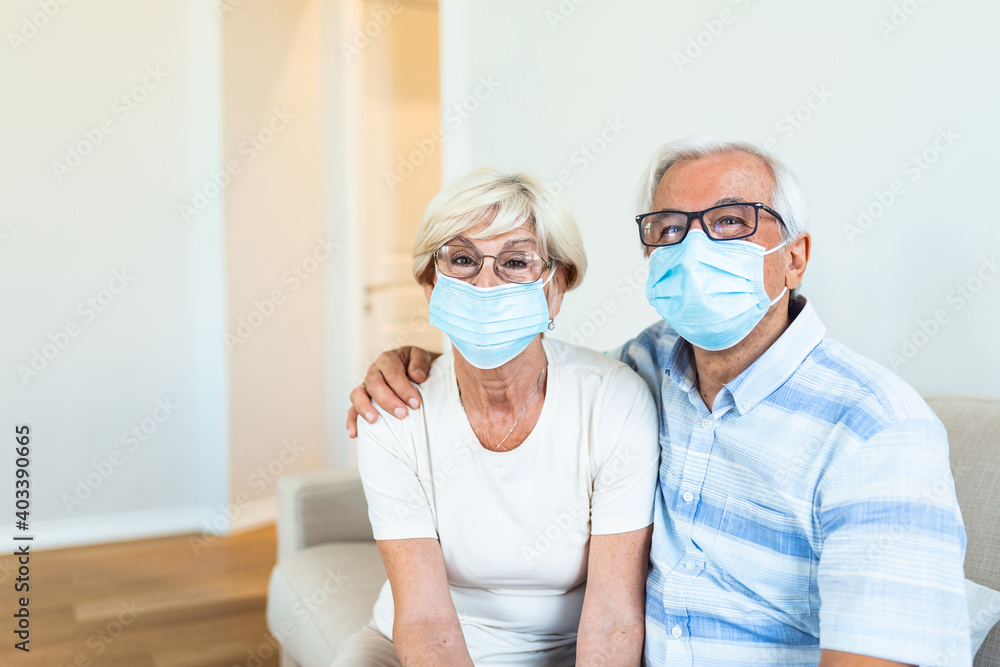 Senior couple wearing medical face mask recovery from the illness at the home. Senior couple with protective mask in quarantine at home during coronavirus covid-19 pandemic