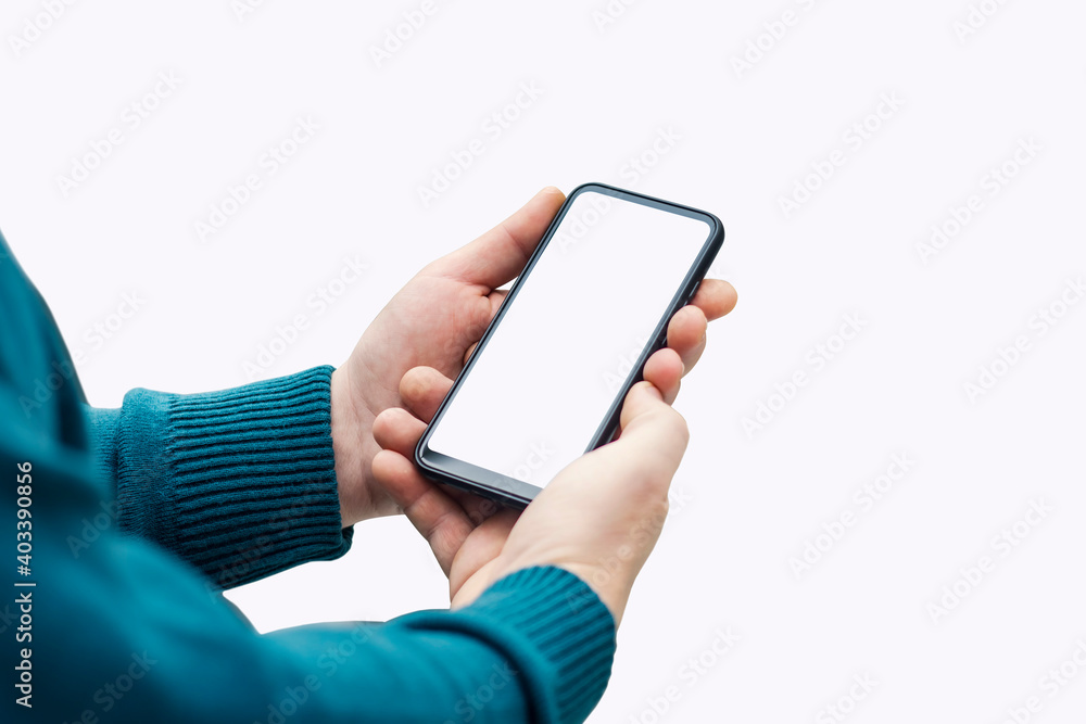 Man holding mock up smartphone with white display close up isolated on white background. Man holding mock up smartphone with white display close up isolated on white background.