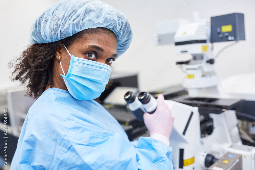 Researcher at microscope searching for Covid-19 vaccine Researcher at microscope searching for Covid-19 vaccine