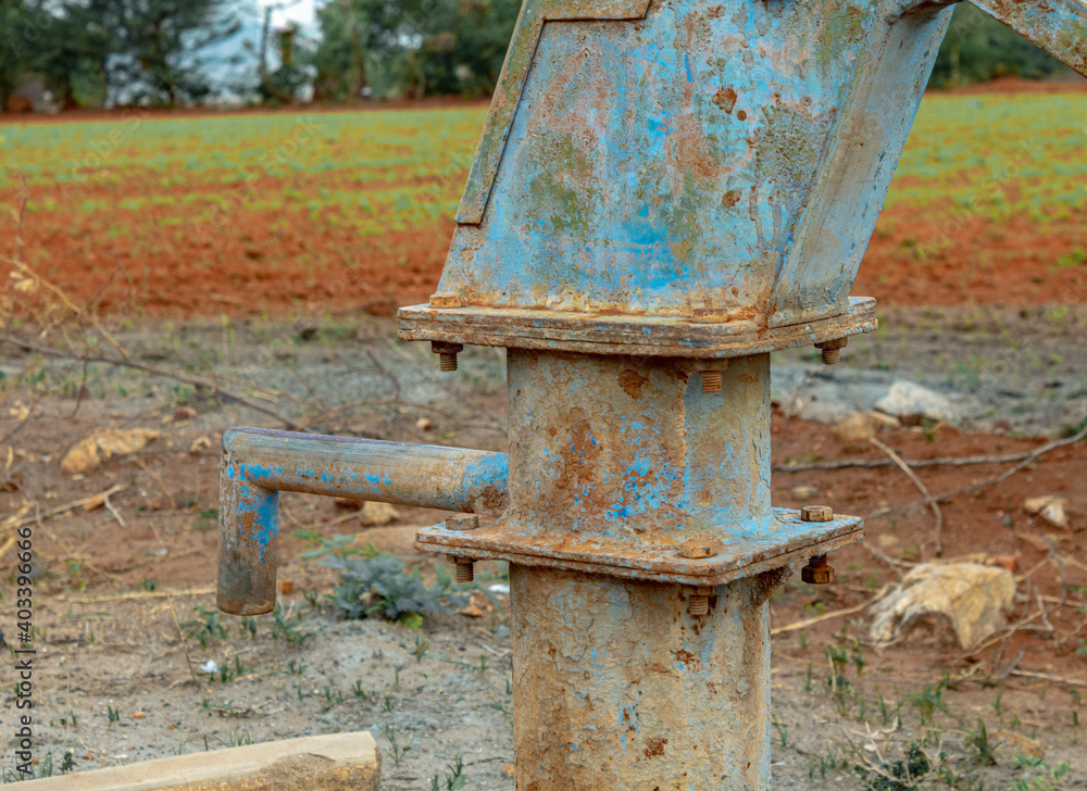 Old Water Pump near grass field used for Farming Old Water Pump near grass field used for Farming