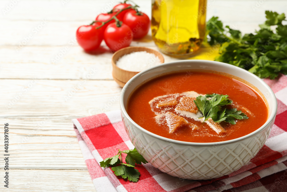 Concept of tasty food with tomato soup on wooden background Concept of tasty food with tomato soup on wooden background