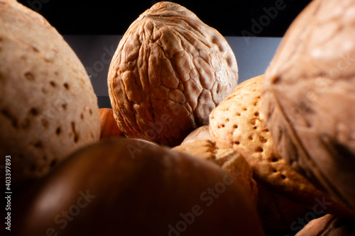Macro walnut in its shell in a bowl of mixed nuts