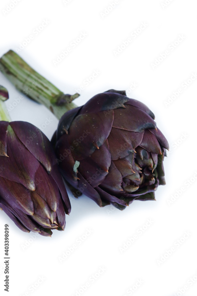 Fototapeta premium Fresh raw artichokes isolated on a white background. Cut Cynara scolymus 