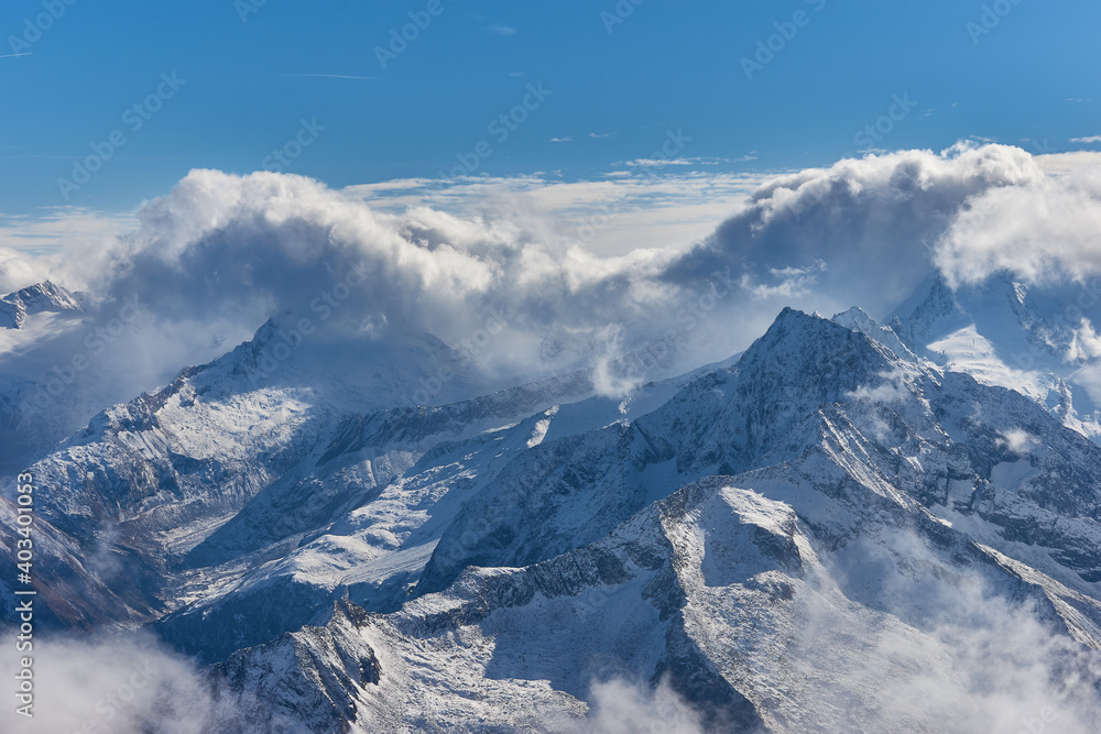 Snow-covered Austrian Alps under the clouds