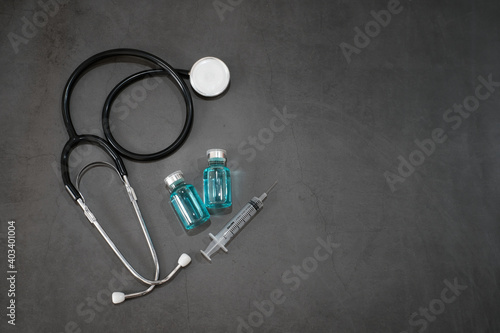 Top view stethoscope and vaccine bottle and syringe on table desk background with copy space, Protect from Coronavirus or COVID-19 epidemic concept