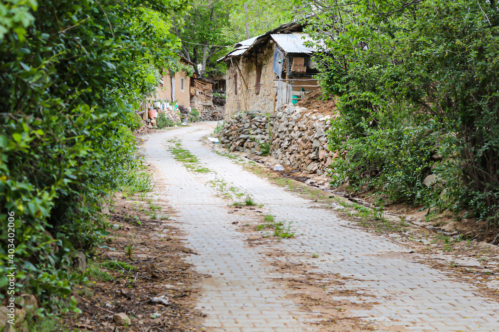 winding stone road and village houses in the countryside. winding stone road and village houses in the countryside.