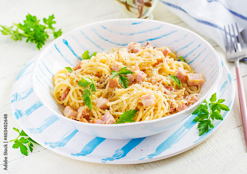 Classic homemade carbonara pasta with pancetta, egg, hard parmesan cheese and cream sauce. Italian cuisine. Spaghetti alla carbonara. Classic homemade carbonara pasta with pancetta, egg, hard parmesan cheese and cream sauce. Italian cuisine. Spaghetti alla carbonara.