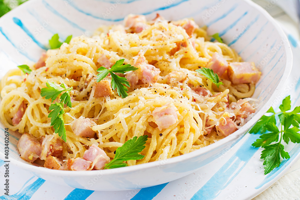 Classic homemade carbonara pasta with pancetta, egg, hard parmesan cheese and cream sauce. Italian cuisine. Spaghetti alla carbonara. Classic homemade carbonara pasta with pancetta, egg, hard parmesan cheese and cream sauce. Italian cuisine. Spaghetti alla carbonara.