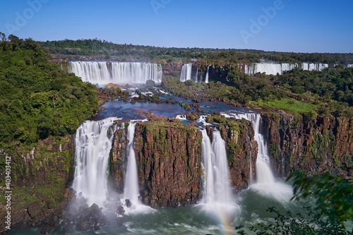 Iguazu Falls or Iguacu Falls, on the border of Argentina and Brazil, are the largest waterfall in the world. Very high waterfall with white water in beautiful rain forest landscape in the jungle