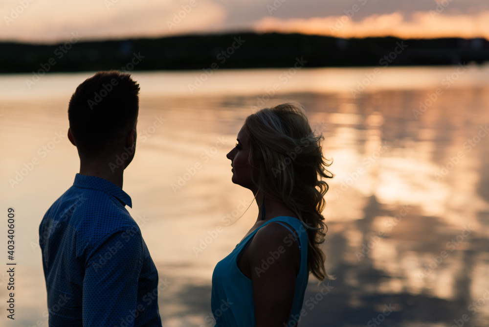 Loving couple kissing on the nature, summer evening Loving couple kissing on the nature, summer evening