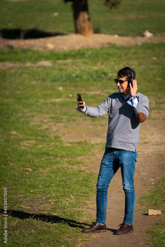 Young man making a video call from his mobile phone Young man making a video call from his mobile phone