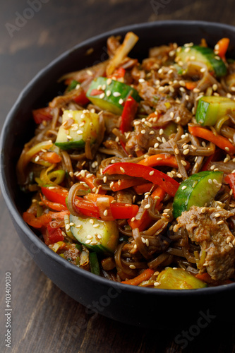 Noodles with vegetables and meat close up