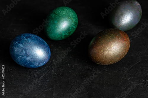 colorfull marble painted easter eggs on black background. Concept of minimal festive Easter backdrop