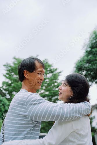 Portrait of senior couple embracing each other at park.