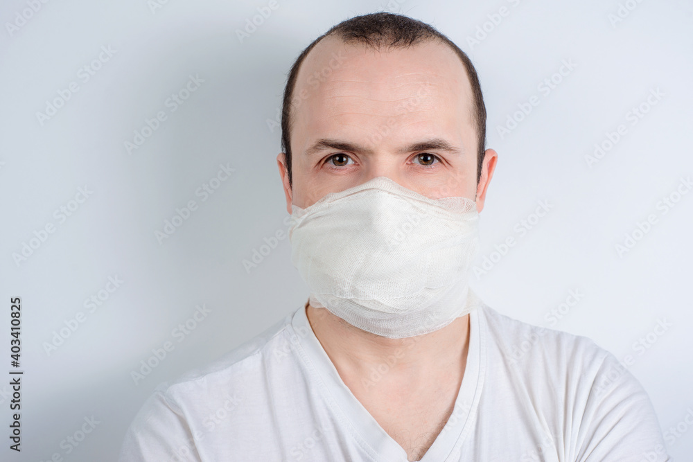 man in a medical mask on a white background, protection against viruses and bacteria man in a medical mask on a white background, protection against viruses and bacteria