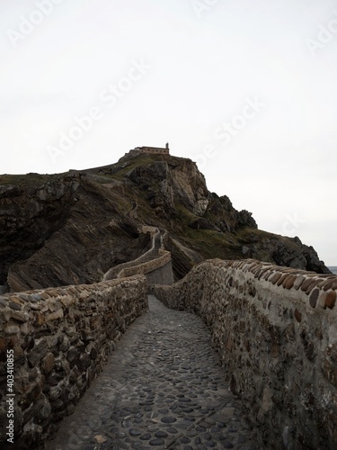 Panoramic view of stone staircase footbridge to Gaztelugatxe islet rock castle hermitage chapel Bermeo Basque Spain photo