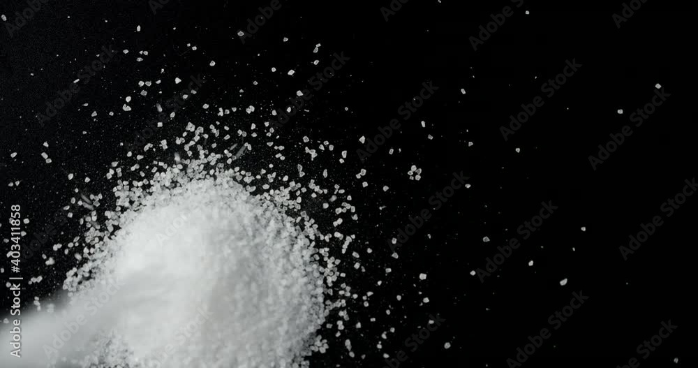 Salt is pouring on the table. Salt is pouring on the table.