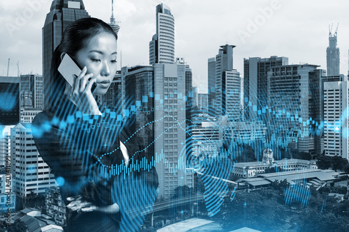 Photography Attractive Asian businesswoman trader processing conference call to forecast the capital market behavior