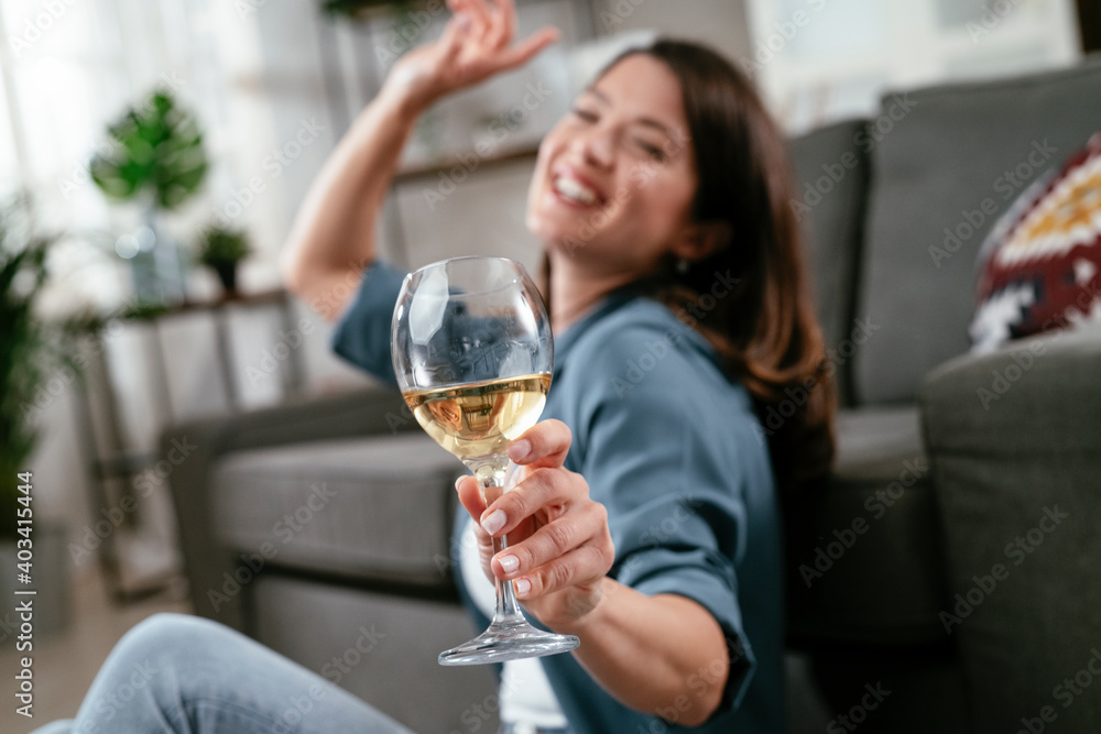 Beautiful woman drinking wine. Young woman celebrate with wine at home Beautiful woman drinking wine. Young woman celebrate with wine at home