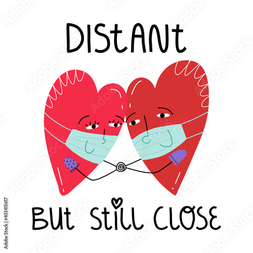 A couple of a hearts in face masks, a lettering Distant but still close.Valentine's day during Covid-19 pandemic concept