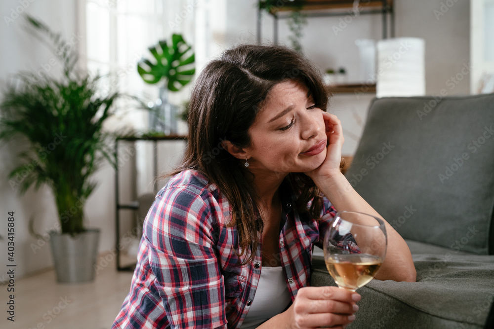 Beautiful woman drinking wine. Young woman having video call, talking and drinking wine at home. Beautiful woman drinking wine. Young woman having video call, talking and drinking wine at home.