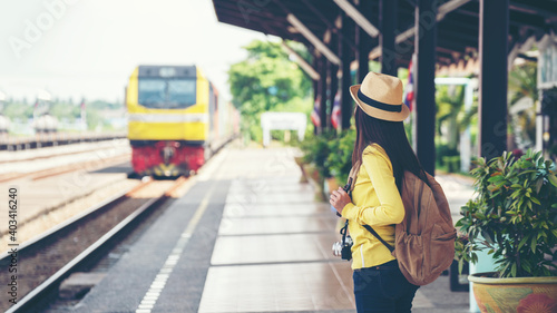 Traveler and tourist asian young women wearing backpack holding map waiting train for leisure and destination travel. Travel Concept.